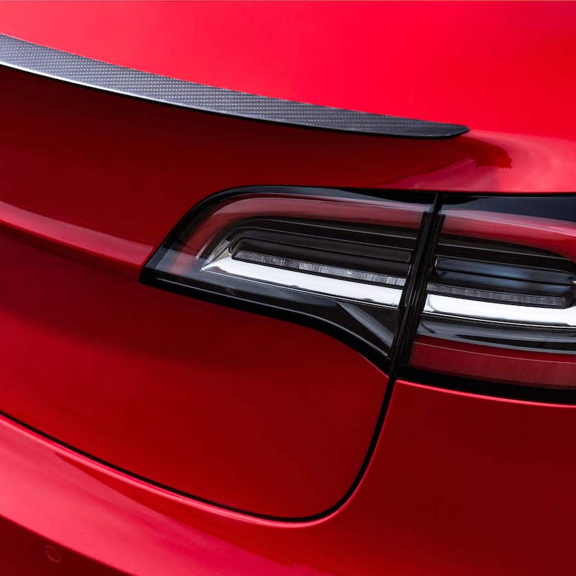 Tesla genuine carbon fibre spoiler on red Model 3
